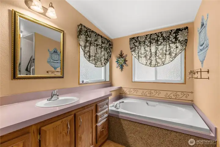 Extra large tub in primary bathroom.