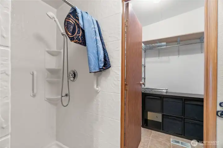 Walk in shower with safety handles.