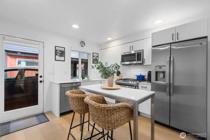 Modern kitchen with ample cabinetry, pantry, & generous prep space.