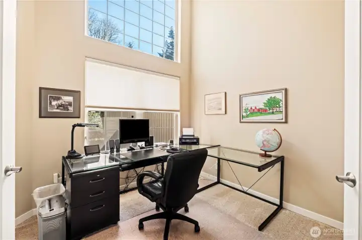 This private office is well lit and offers peek a boo views of the natural beauty outside.