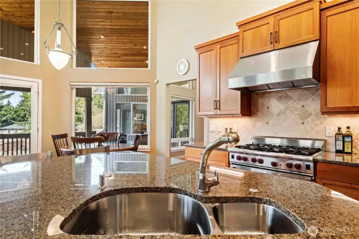 Notice how the gourmet kitchen flows easily into the dining area.  All areas of the great room (kitchen, dining and family room) have amazing territorial views.