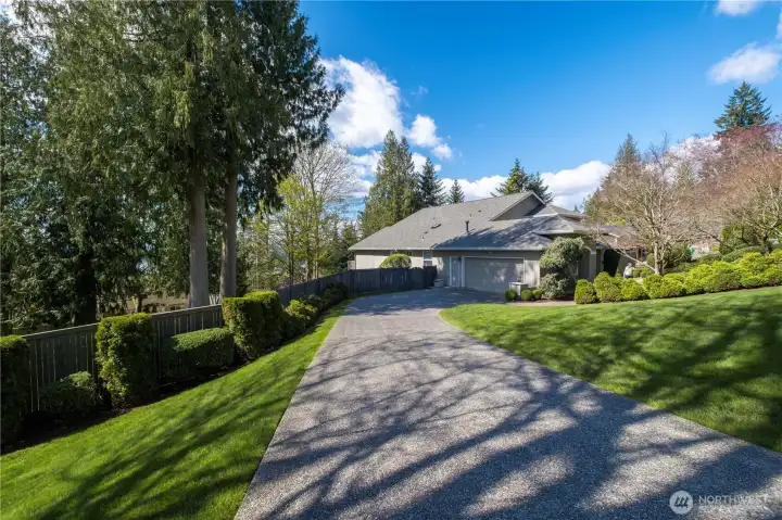 The elongated driveway winds through the well landscaping yard to make the approach to the home just as impressive as the house itself.