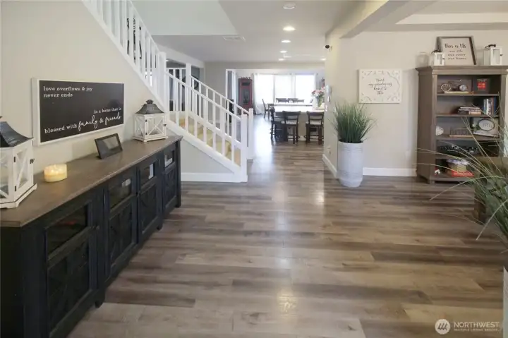 The spacious entry with office space on your right, main floor bedroom to your left, and the open concept living straight ahead!