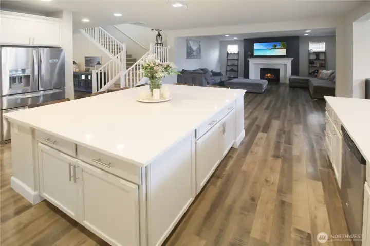 The open concept kitchen flows into the living room and dining room to the right.
