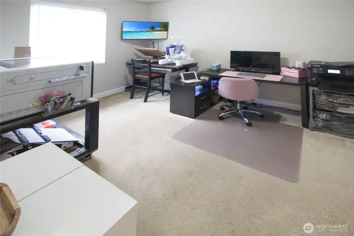 Currently used as a creative workspace, this main floor bedroom is spacious and located right next to the main floor bathroom.