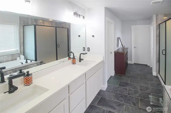The stunning primary ensuite features stunning upgrades throughout as well as TWO walk-in closets!