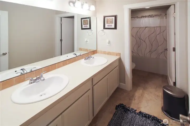 The upstairs full bathroom includes dual vanities as well as a privately enclosed toilet & shower - great for maximizing a shared space!