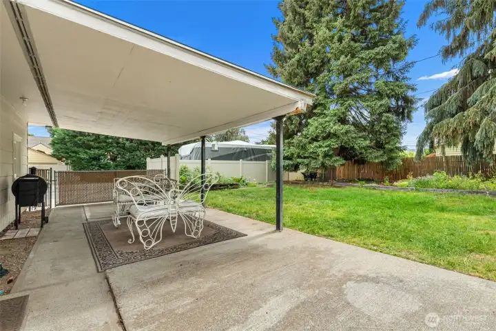 Backyard with carport or covered patio. Backyard with carport or covered patio.