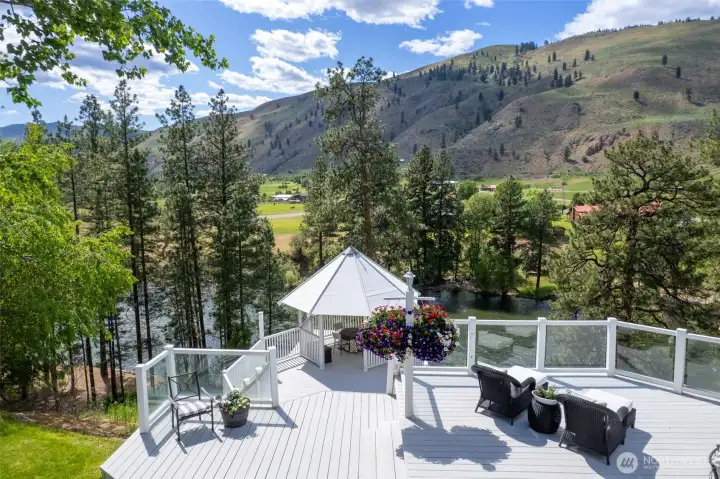 "Private riverfront setting with expansive decks, gazebo, mature trees and direct access to the Methow River."