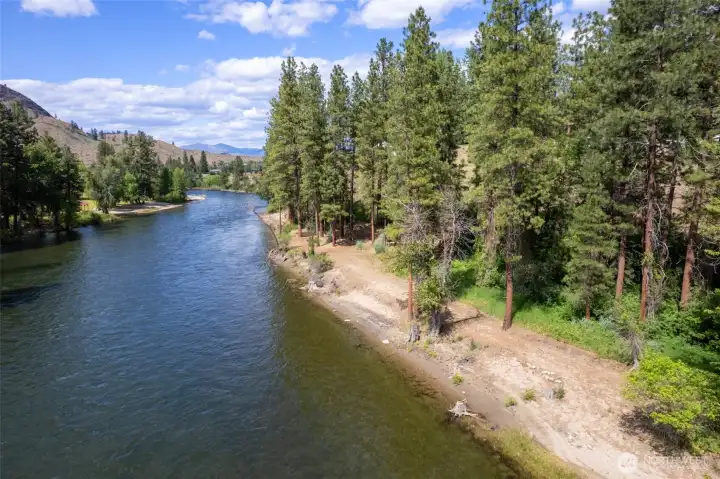 "Perched above the riverbank, the residence enjoys privacy, elevated views and a commanding riverfront shoreline."