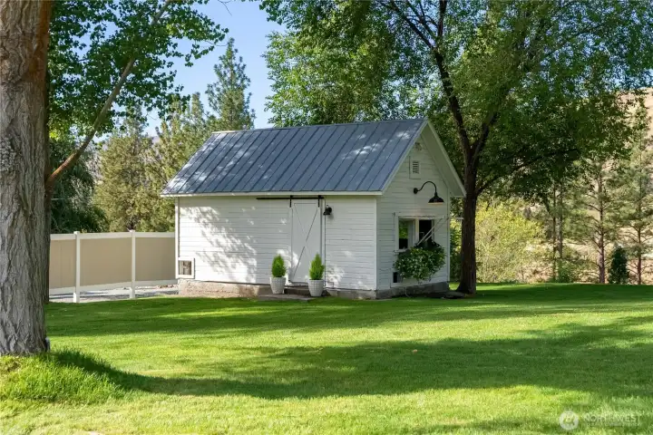 Charming garden shed provides convenient storage for tools, equipment, and seasonal projects.