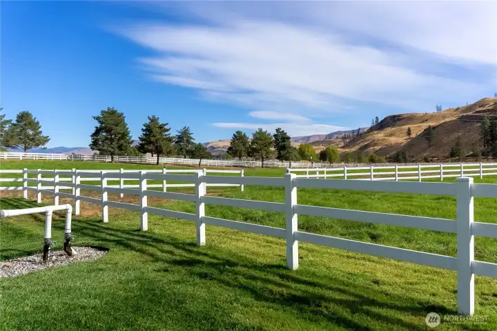 Irrigated pasture framed by white fencing and open sky—an idyllic pastoral setting for livestock, hay, recreation, or simply soaking in the Methow’s peaceful rhythm.