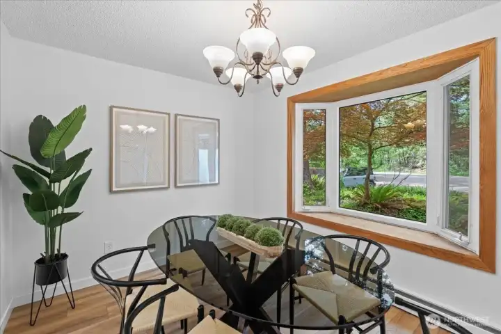 Dining Room – Dedicated dining area featuring a large bay window that brings in natural light and showcases views of the surrounding landscape.
