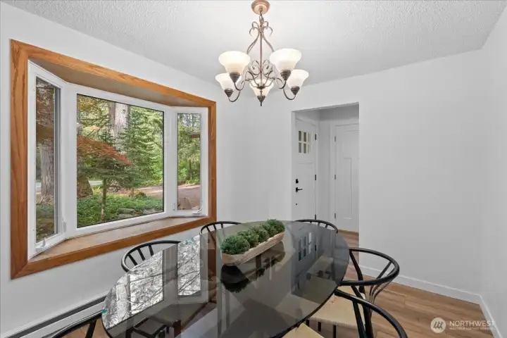 Dining Room – Spacious dining space with contemporary lighting and expansive bay window seating area overlooking the front yard.