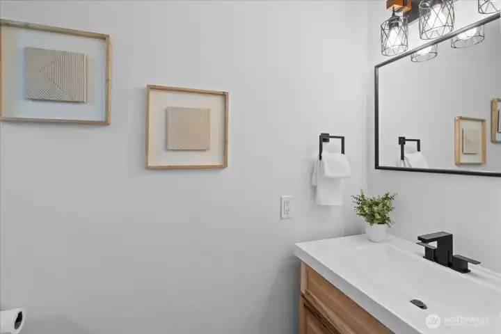 Bathroom – Main-level powder room featuring updated vanity, modern fixtures, and clean contemporary finishes.
