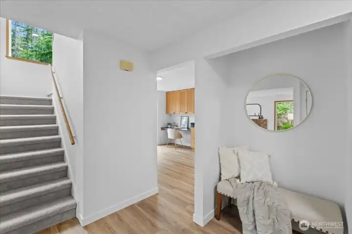 Entry Hall – Welcoming foyer with updated flooring, staircase access, and convenient connection to the kitchen and living areas.