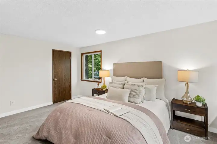 Primary Bedroom – Well-proportioned primary bedroom featuring fresh carpeting, abundant natural light, and room for a variety of furniture arrangements.