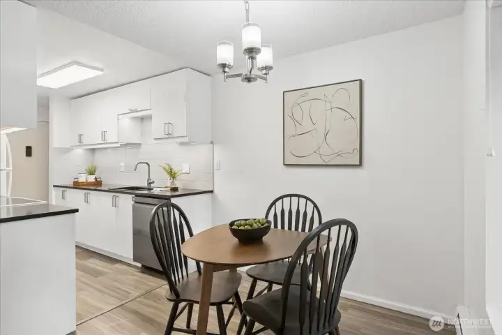 Galley kitchen opens to a cozy dining area.