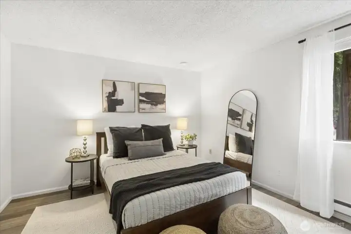 The primary bedroom is tucked into the corner of the unit and brings in plenty of natural light.