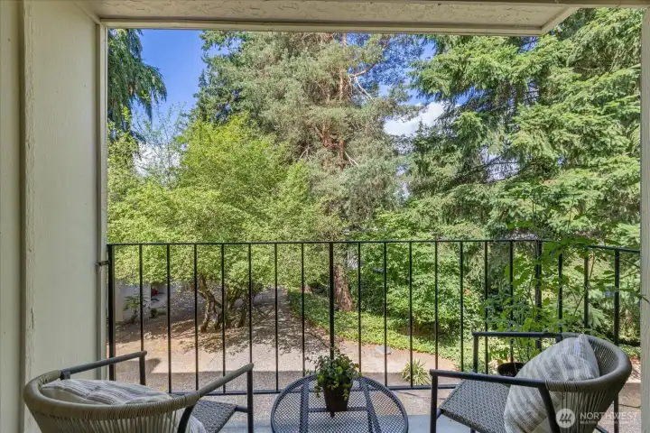 Welcome to your own private balcony, looking out onto mature greenery.
