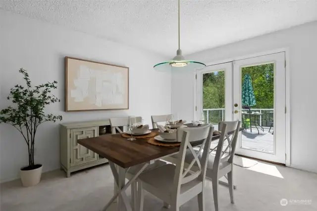 A spacious dining area is situated between the living room and kitchen for easy access. Enjoy the outdoors with french doors leading to an expansive deck.