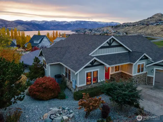 Aerial view of home w/ uplake Lake Chelan views and large, landscaped lot.