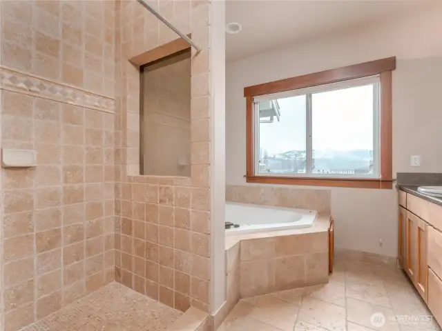 View of the main level Primary Bedroom Bathroom Suite w/ double vanities, granite countertops, European tiles and a spa-like Jacuzzi tub.
