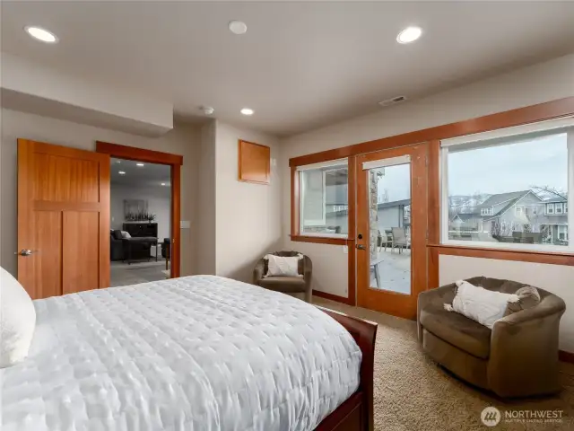 View 2 of lower level 2nd Primary Bedroom Suite w/ French doors leading to the outdoor living area complete w/ dining, lounge and BBQ areas.