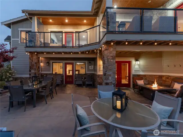Aerial twilight view 2 of the 5bd/4th 3,441sf home w/ upper level Lake Chelan view decks and lower level outdoor living area w/ dining, lounge and BBQ area.