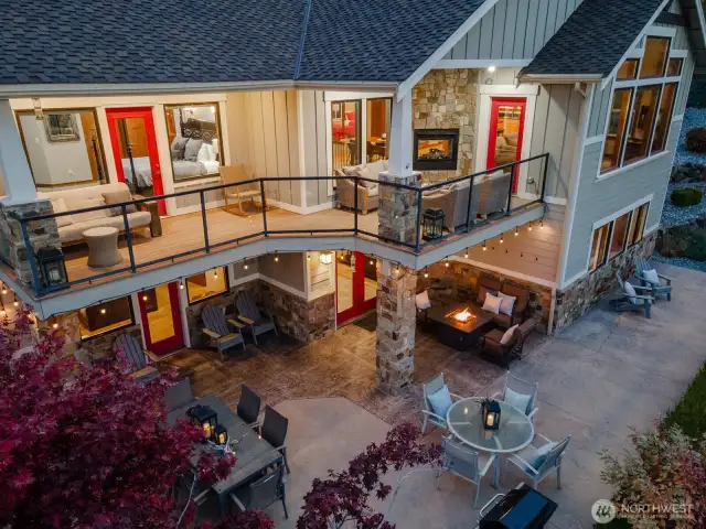 Aerial twilight view 3 of the 5bd/4th 3,441sf home w/ upper level Lake Chelan view decks and lower level outdoor living area w/ dining, lounge and BBQ area.