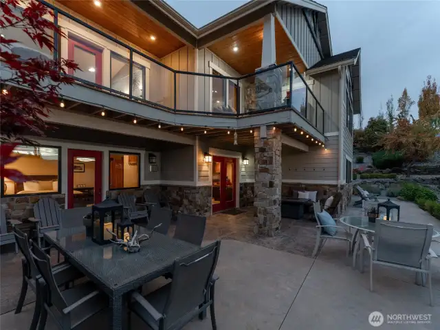 Twilight view of outdoor living area w/ dining, lounge and BBQ areas.