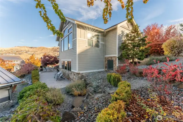 Exterior view of home w/ large landscaped lot.
