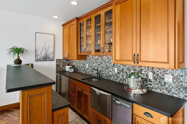 Bar is fully equipped with ice machine, sink, single drawer Fisher & Paykel.  Mini under counter frigerator and wine chiller/refrigerator.  Plenty of storage for your cocktails bottles of choice and glassware.