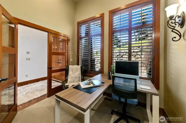 Office off main entryway with double doors, vaulted ceilings and plenty of storage for the printer and office supplies.  View here is the front yard and driveway.  Deadend street