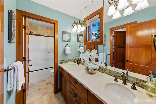 Jack n Jill bathroom for the two upper level bedrooms.  Double marble counter top sinks, shower tub combo and toilet in separate room.