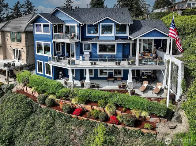 Drone from Southside of home.  Landscaped for low maintenance. Wonderful three stories of a masterpiece.