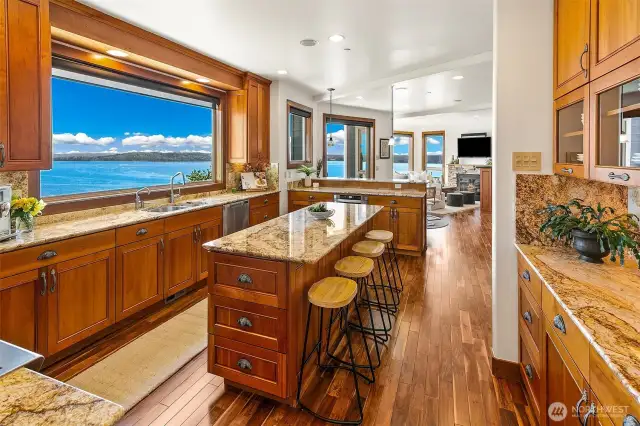 Kitchen offers many hidden gems, warming drawer, trash compactor, pull out drawers, Sub Zero full refrigeration doors and drawers, island microwave, double ovens with gas cooktop griddle.