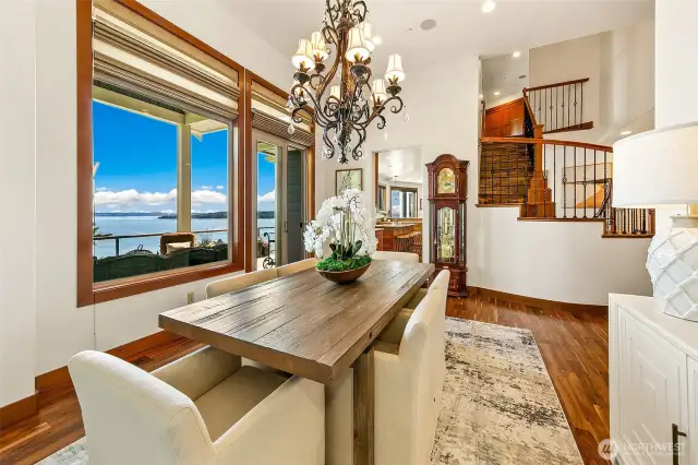 Dining Room with access to covered main floor deck with views.  Looking into the kitchen and stairs to upper level livings quarters.