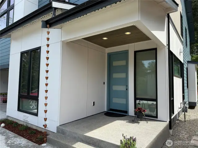 Welcoming Covered Entry with Beautiful Wood Ceiling with Recessed Lighting. Notice the Beautiful Stylish Front Door with Glass Panels.