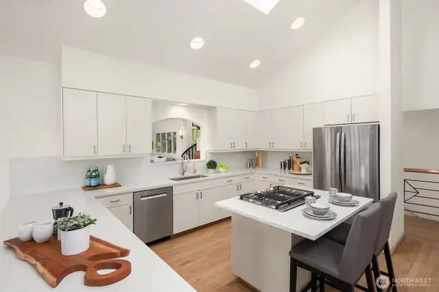 Gleaming quartz counters and brand new appliances make this epicurean dream kitchen a pleasure to cook in.