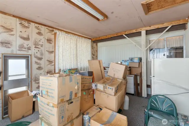Addition that has the kitchen on the far wall.  Currently storing moving boxes to prepare for the move.