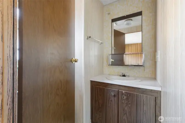 Primary 1/2 bath, commode behind door