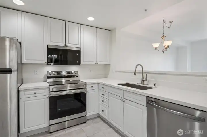 updated kitchen with new countertops, sink/faucet and new appliances
