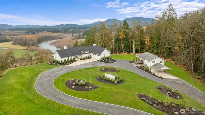 This property spans 18.5 acres of parklike grounds adorned with towering old-growth trees, sweeping territorial views, professional landscaping with lighting and circular driveway with curbing detail!