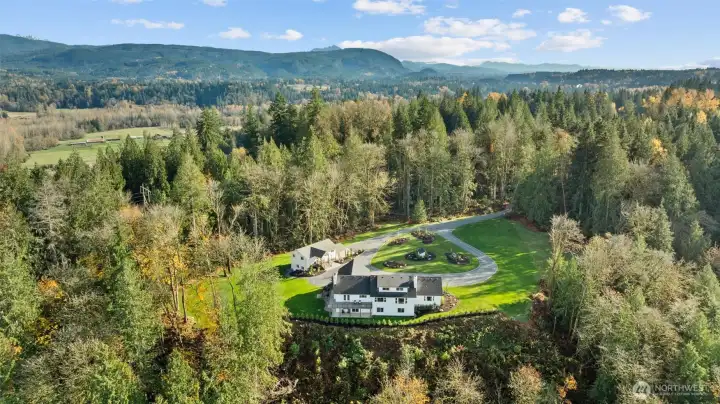 This property spans 18.5 acres of parklike grounds adorned with towering old-growth trees and sweeping territorial views. Zoned R5 for potential future expansion!