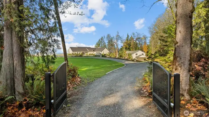Nestled down a private, serene driveway with custom iron gate with electronic keypad.