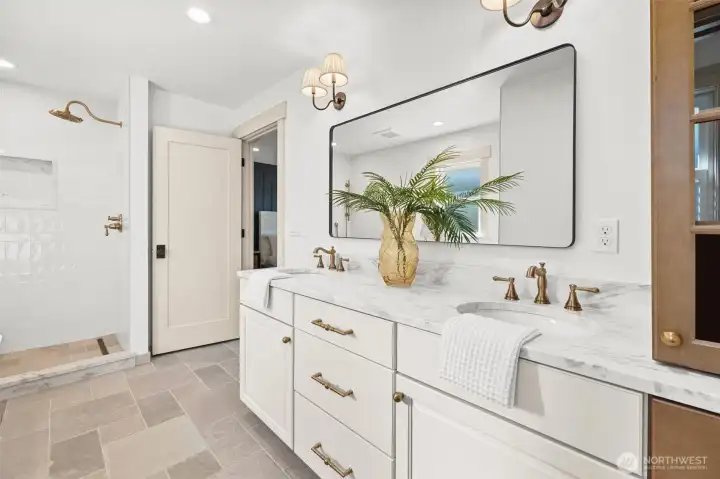 Primary ensuite bathroom with custom cabinetry, marble countertops and high-end plumbing fixtures. Separate water closet with pocket door, recessed lighting and coordinating wall sconces, on dimmers for ambience.