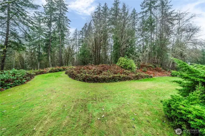 Lots of flat lawn space that includes a fire pit and mutltiple patios and decks.