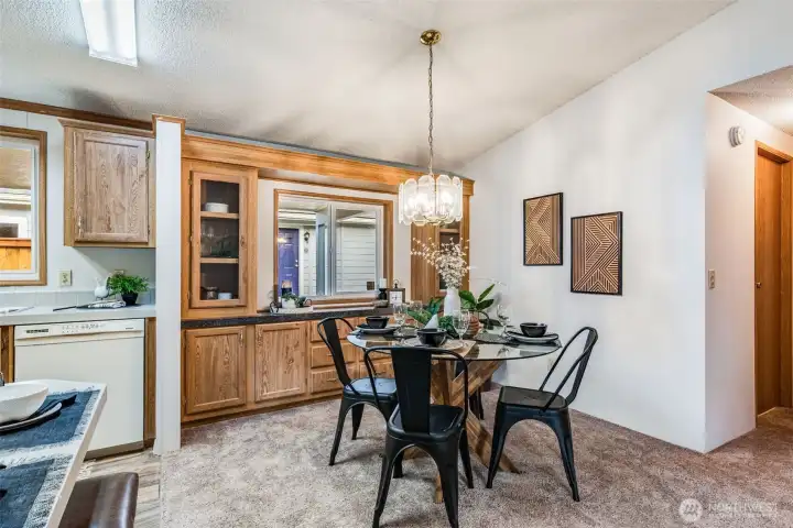 The dining area is equipped with a china cabinet and built in buffet countertop for serving.