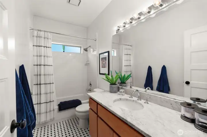 2nd bathroom with tile work and marble counters